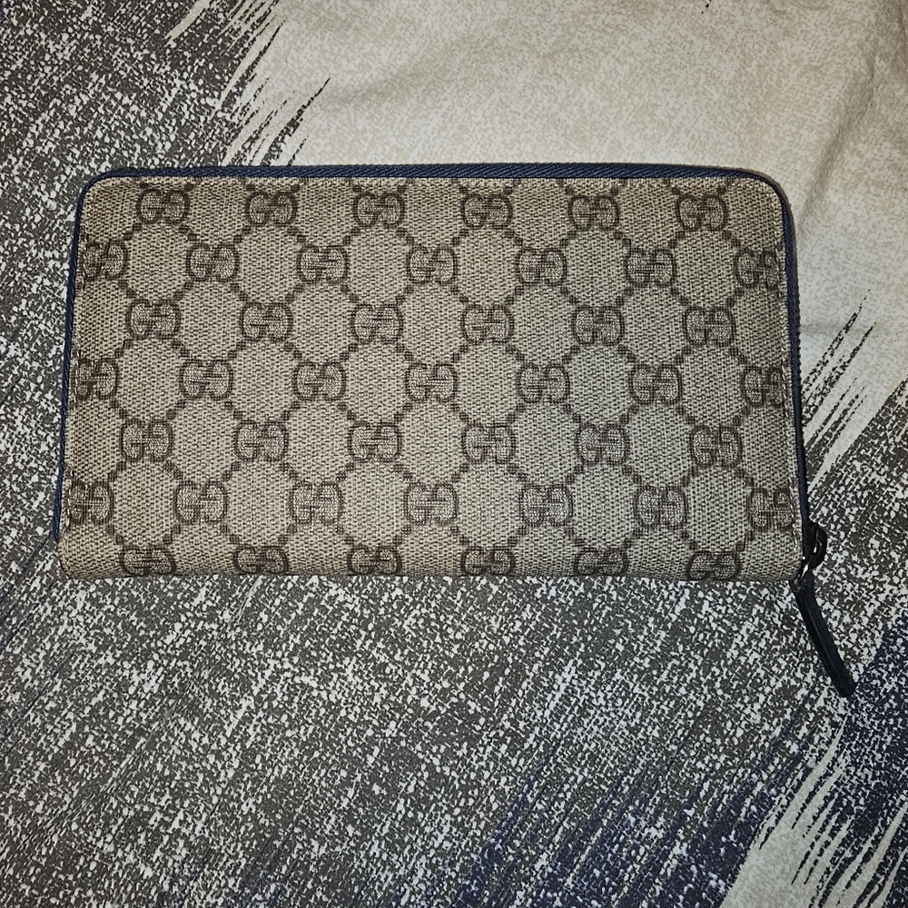 Gucci long wallet with a blue leather interior.